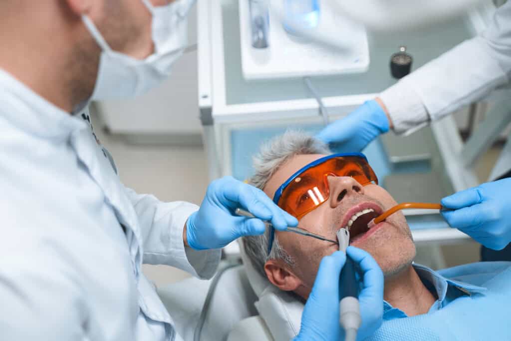 the patient is lying in dental clinic for having its dental bone grafting done.