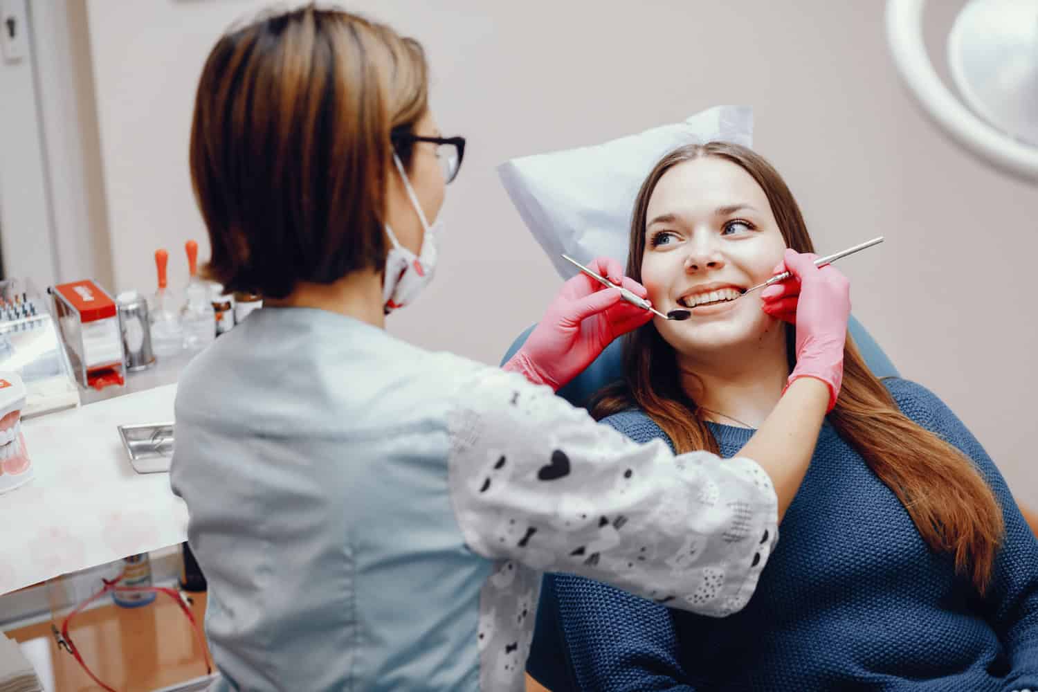 Periodontist examining a patient’s teeth and gums during a dental appointment.