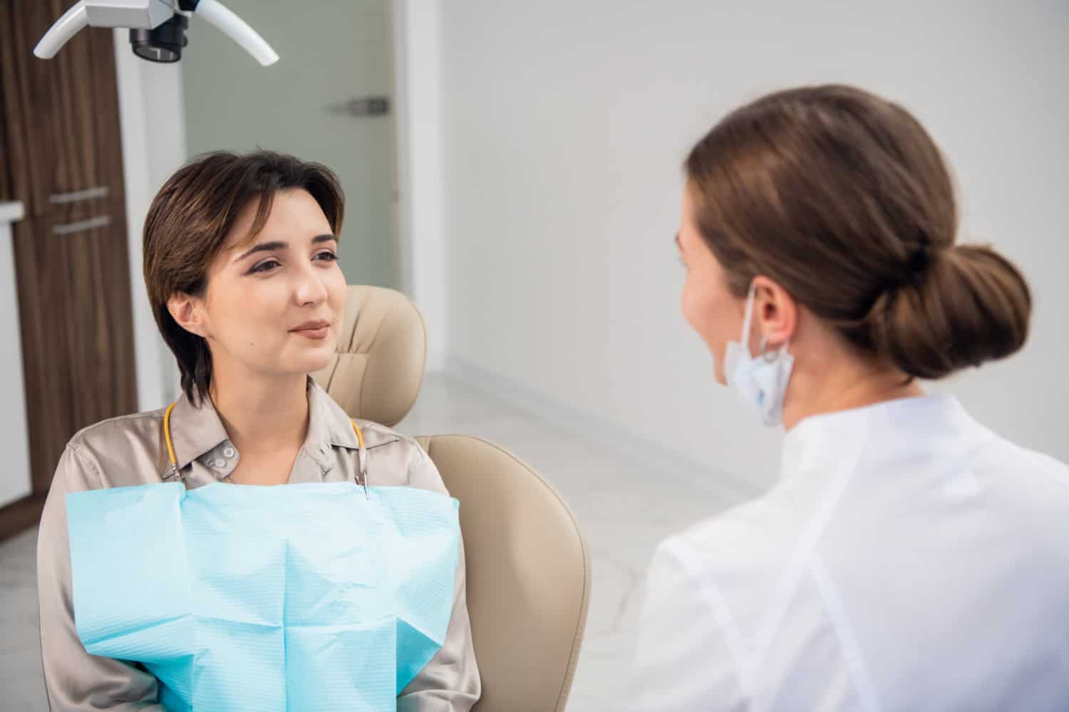 Periodontist discussing dental treatment options with a patient during a consultation.