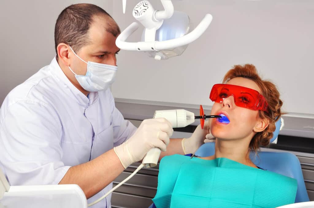 Laser gum surgery treatment performed by a periodontist using dental laser technology for a patient.