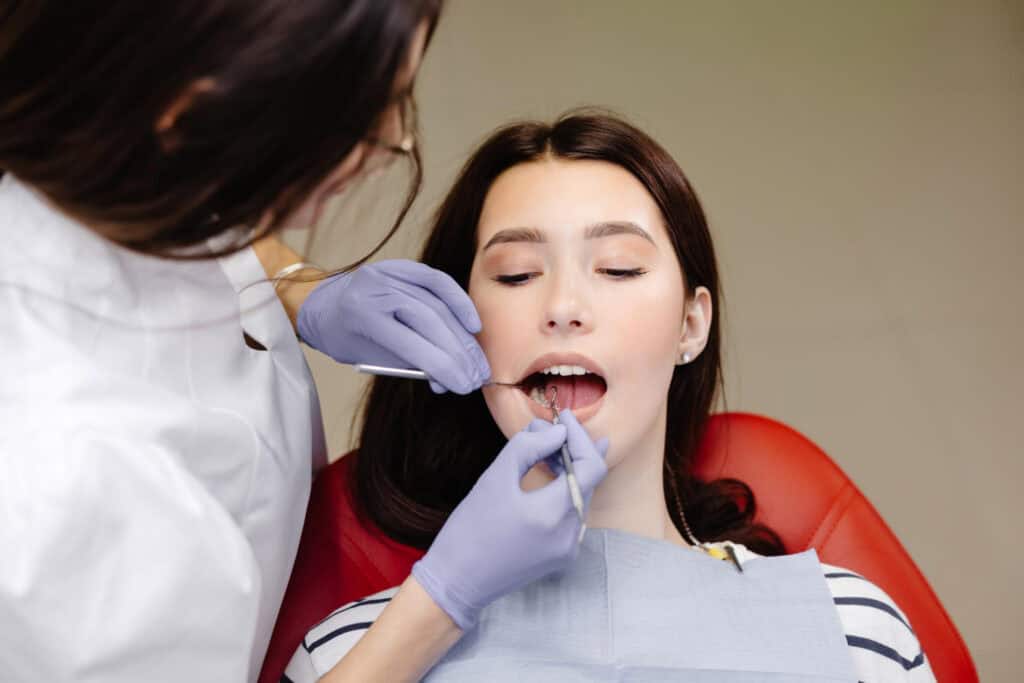 Periodontist examining patient during a gum disease treatment and periodontal care consultation in Timonium, MD.
