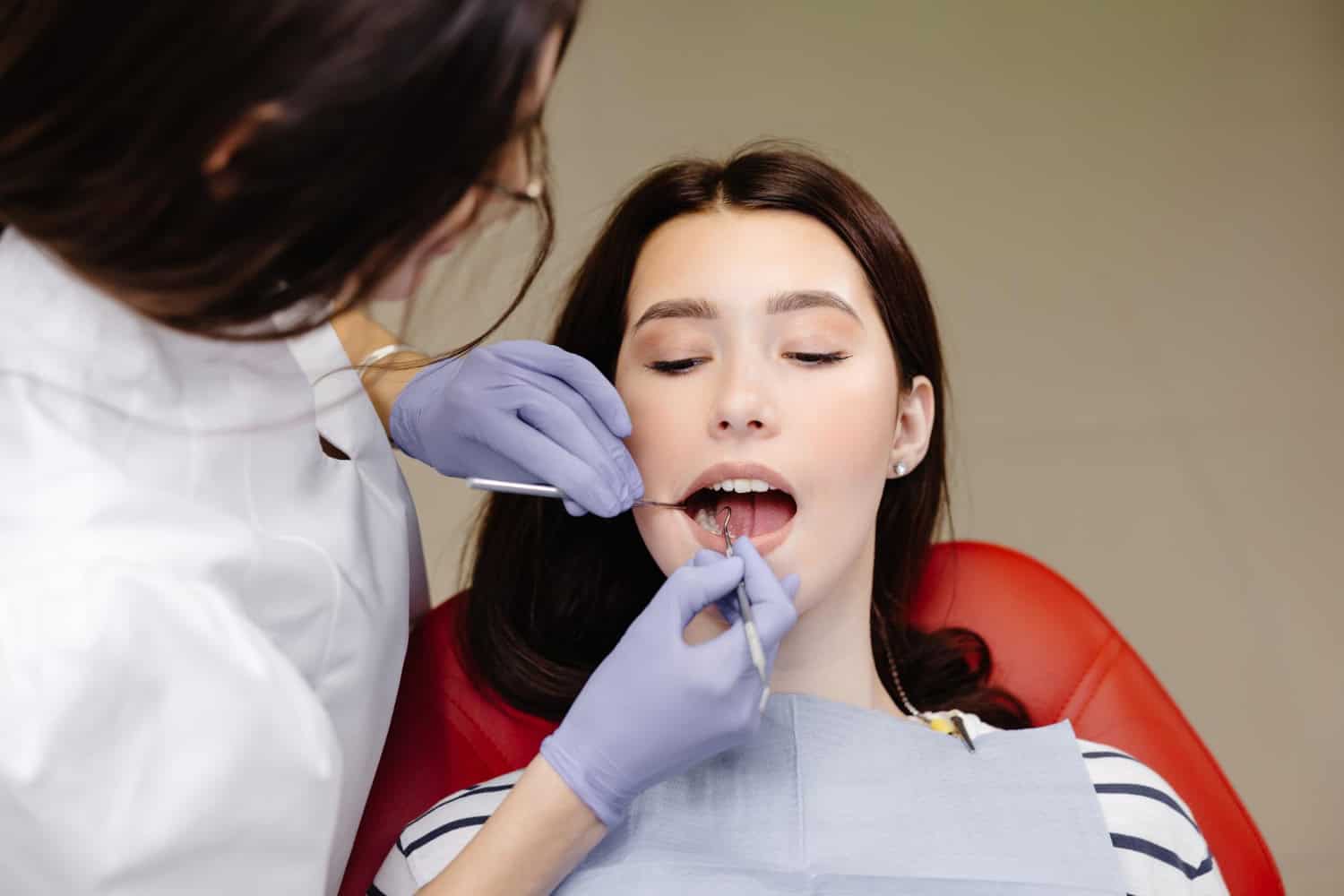 Periodontist examining patient during a gum disease treatment and periodontal care consultation in Timonium, MD.