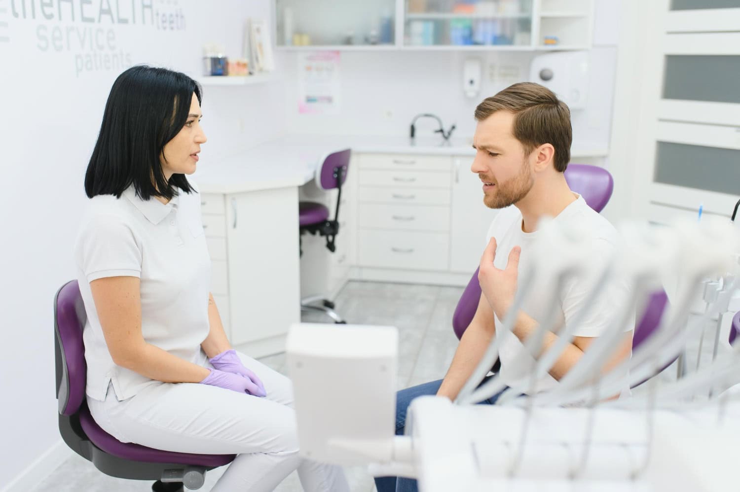 Periodontal consultation with a dental professional discussing treatment options with a patient.