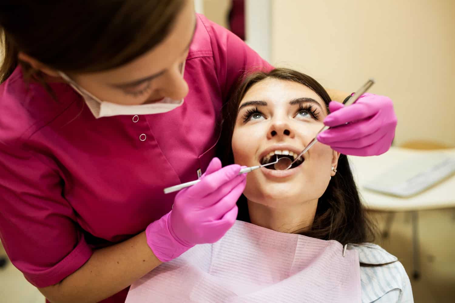 Dental professional examining a patient’s teeth during a periodontal dental examination.