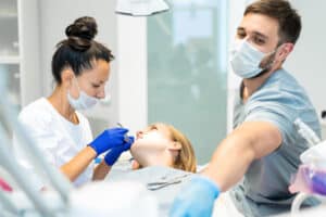 Tooth extraction procedure with a dental team preparing a patient for tooth removal in a modern dental office in Timonium, MD.