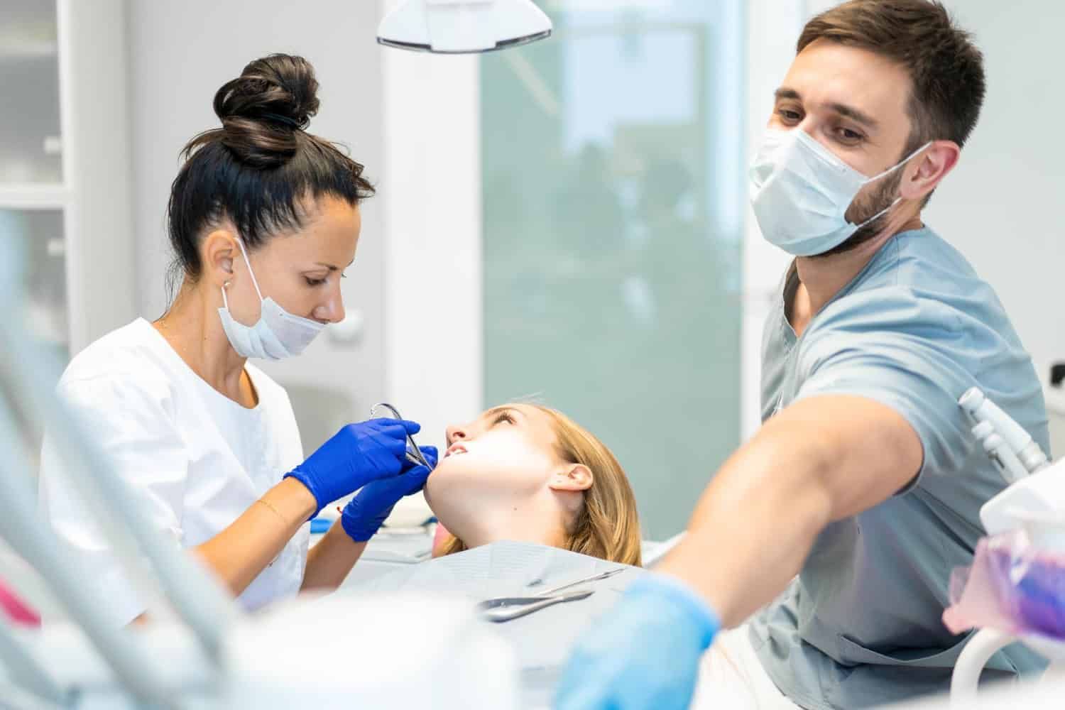 Tooth extraction procedure with a dental team preparing a patient for tooth removal in a modern dental office in Timonium, MD.